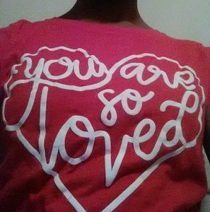 A red "you are so loved" tee